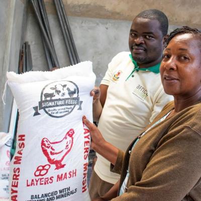 Assistant Tagdev Program Coordinator Prof. Patience Mshenga And Tagdev Administrative Assistant Holding One Of The Products At Trendy Animal Feeds